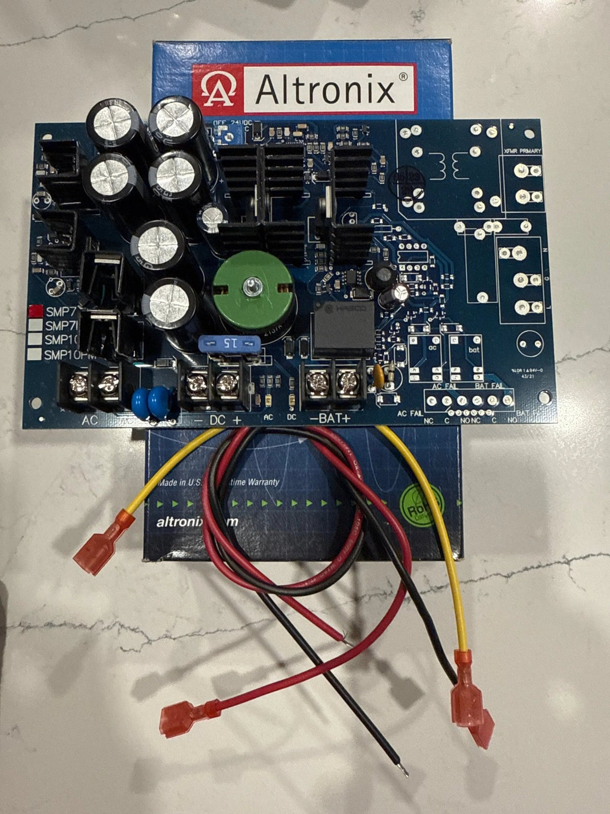Altronix SMP7 board-level power supply and battery charger with selectable 12VDC or 24VDC output at up to 6 amps.